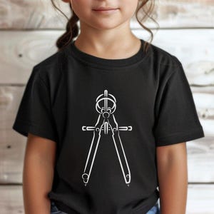 May include: Black t-shirt featuring a white graphic of a compass, a tool used for drawing circles and arcs. The shirt is worn by a person. The word "Black" is in a black circle in the upper left corner.
