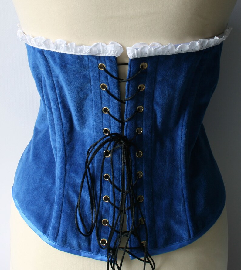 May include: A blue velvet corset with a white lace trim and black lacing in the back.