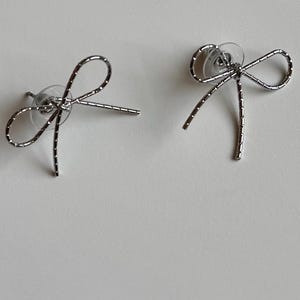 Textured Silver Bow Drop Earrings | Dainty Metal Ribbon Statement Jewelry