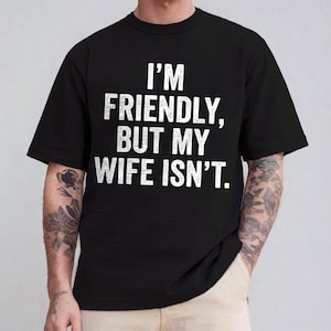 May include: A white ceramic mug with a black handle and the text "But First, Coffee" in a black, bold font. The mug is on a white surface.
