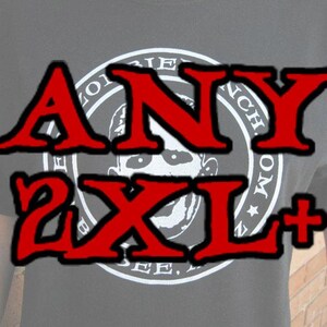 May include: Black t-shirt with a white circle graphic featuring a skull and the text "FRIENDS FOREVER" in a circular design. The text "ANY 2XL+" is written in red across the front of the shirt.