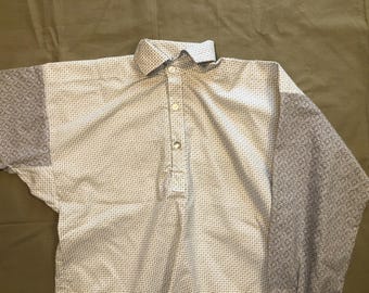 May include: A white collared shirt with a small, repeating pattern. The sleeves are a contrasting gray with a geometric design. The shirt has a button-down front and a classic collar.