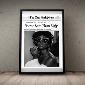 May include: Black and white framed print featuring a woman wearing sunglasses and a headscarf, holding a lollipop. The print is designed to look like a newspaper front page with the headline "Better Late Than Ugly."