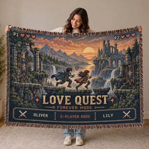 以下が含まれることがあります： ファンタジーな風景の中を二人のキャラクターが駆け寄る様子が描かれた織りブランケット。LOVE QUEST、FOREVER MODE、2-PLAYER MODE、OLIVER、LILYの文字に加え、ハートのアイコン、剣、夕日の背景がデザインされています。