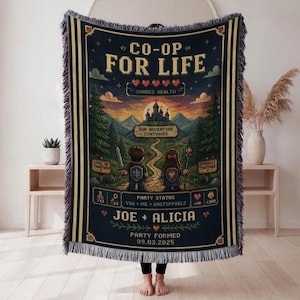 May include: A woven throw blanket featuring a dark blue background with a pixel art fantasy landscape. The text reads CO-OP FOR LIFE, JOE + ALICIA, and 09.03.2025. It depicts two characters walking toward a castle, surrounded by trees and mountains.