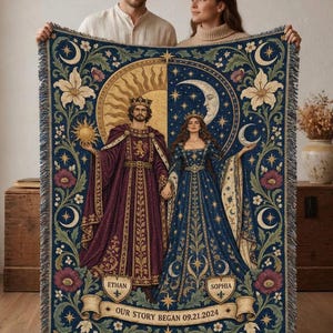 May include: A woven throw blanket featuring a split sun and moon design with a king and queen figure. The text reads ETHAN, SOPHIA, and OUR STORY BEGAN 09.21.2024. The blanket has a dark blue background with gold, purple, and cream floral accents.