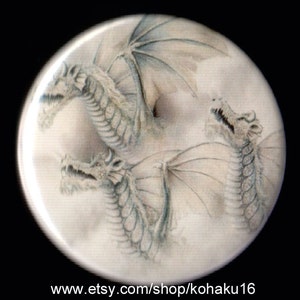 May include: A white background with three white dragons with wings, drawn in a watercolor style.