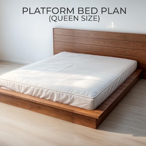 May include: A wooden platform bed with a headboard and a mattress. The bed frame and headboard are made of a warm-toned wood. The mattress is white. Text on the wall reads "PLATFORM BED PLAN (QUEEN SIZE)".