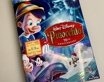 May include: A DVD cover for the Platinum Edition of the Walt Disney movie Pinocchio. The cover features a colorful illustration of Pinocchio, Geppetto, and other characters from the film. The text on the cover reads "Walt Disney Pinocchio 70th Anniversary".