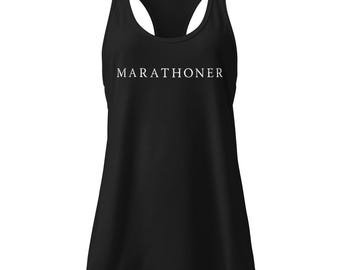 May include: Black racerback tank top with the word "MARATHONER" printed in white across the chest. The tank top has a scoop neck and a racerback design, suitable for athletic activities.