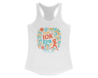 May include: White racerback tank top with a colorful graphic. The graphic features the text "IN MY 10K Era" with a running figure and floral accents in orange, teal, and yellow. The text "The Pace Life" is below.