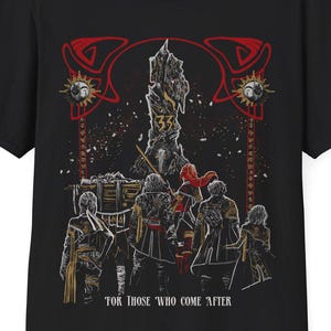 May include: Black t-shirt featuring a detailed graphic design. The design includes a central tower, figures in cloaks, and decorative elements in red and gold. The text "FOR THOSE WHO COME AFTER" is printed below the graphic.