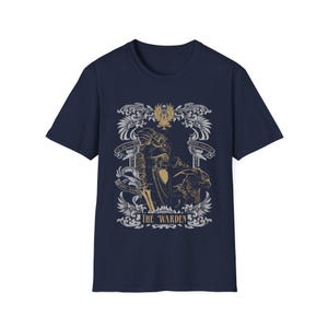 May include: Navy blue t-shirt with a graphic of a figure in armor holding a sword. The graphic is surrounded by ornate details and the text "THE WARDEN".