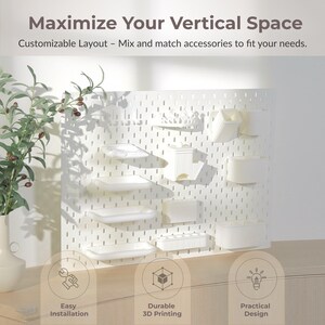 May include: White pegboard with various white accessories, including shelves and containers. Text reads "Maximize Your Vertical Space" and "Customizable Layout - Mix and match accessories to fit your needs."