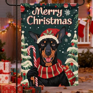Puede incluir: Una bandera de jardín navideña con un perro negro con un gorro de Papá Noel y una bufanda roja y blanca, sosteniendo un bastón de caramelo. La bandera tiene las palabras "Merry Christmas" sobre un fondo verde oscuro con copos de nieve y diseños de árboles de Navidad.