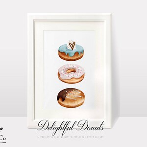May include: A white frame with a white mount and a white background. The image shows three doughnuts stacked on top of each other. The top doughnut is blue with white icing and a heart-shaped sprinkle. The middle doughnut is pink with white icing and pink sprinkles. The bottom doughnut is brown with chocolate icing and gold sprinkles. The text "Delightful Donuts" is written below the doughnuts.