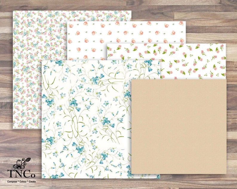 May include: Four sheets of patterned paper with floral designs. The top sheet has a pink floral pattern, the second sheet has a white floral pattern, the third sheet has a blue floral pattern, and the bottom sheet is a solid brown color.