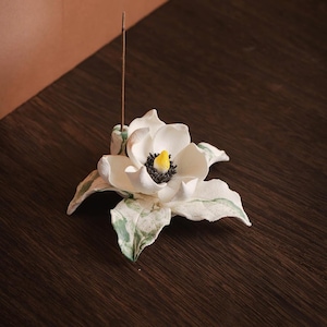 May include: A set of three ceramic mugs with a speckled, matte finish. The mugs are in shades of cream, light gray, and dark gray. Each mug has a simple, minimalist design, perfect for coffee or tea.