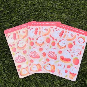 May include: Three rectangular sticker sheets featuring a repeating pattern of small white cartoon chickens interacting with various strawberry-themed desserts. The text "you are im-peck-able" is printed in white along the top edge of each sheet.