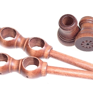 May include: Two wooden curtain rod finials with a decorative design and two wooden curtain rod holders with a smooth finish.