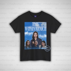 May include: Black t-shirt with a graphic featuring a woman and three others, and the text "THE WATHINWANICH" in white. The image has a blue sky background. The shirt is a Champion brand.