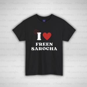 May include: Black t-shirt featuring the text "I ♥ FREEN SAROCHA" in white, with a red heart symbol. The shirt has a crew neck and short sleeves. The text is centered on the front of the shirt.