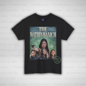 May include: Black t-shirt with a movie poster design. The graphic features the text "THE WATHINWANICH" and images of women. The shirt is a Champion brand.