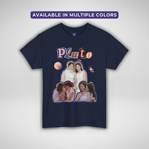 May include: Navy blue t-shirt with the word "Pluto" in a purple and orange font. The shirt features a collage of images of women and the text "AVAILABLE IN MULTIPLE COLORS" at the top.