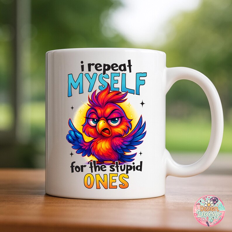May include: White ceramic mug with a colorful cartoon bird illustration. The bird is red, orange, blue, and purple with an angry expression. Text on the mug reads "i repeat MYSELF for the stupid ONES."