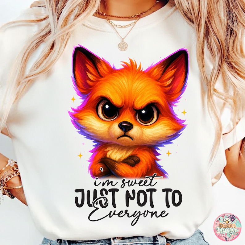 May include: White t-shirt featuring a cartoon fox with an angry expression. The fox is orange, red, and purple with crossed arms. The text "I'm sweet JUST NOT TO Everyone" is below the fox.