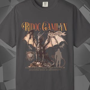 Comfort Colors unisex T-shirt featuring a Fourth Wing fantasy design inspired by the Empyrean Series. Premium quality 100% cotton shirt with a soft, relaxed fit, available in 14 colors and plus sizes. Bookish fantasy apparel inspired by Iron Flame, Onyx Storm, Basgiath War College, Dragon Riders, Fly or Die, and the Riders Quadrant, for fans of Violet Sorrengail, Xaden Riorson, and Rebecca Yarros.
