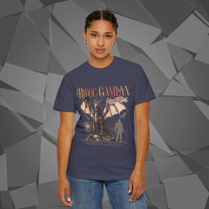 Comfort Colors unisex T-shirt featuring a Fourth Wing fantasy design inspired by the Empyrean Series. Premium quality 100% cotton shirt with a soft, relaxed fit, available in 14 colors and plus sizes. Bookish fantasy apparel inspired by Iron Flame, Onyx Storm, Basgiath War College, Dragon Riders, Fly or Die, and the Riders Quadrant, for fans of Violet Sorrengail, Xaden Riorson, and Rebecca Yarros.