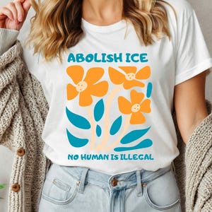 Floral Abolish ICE Human is Illegal Shirt, Political Resistance Shirt, Anti-Trump Activist Wear, No Human is Illegal Top, DACA Shirt VLB1026