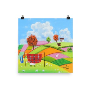 May include: A painting depicting a colourful landscape with a red tartan blanket hanging on a washing line. There is a small white house in the background and a sheep in the foreground. The painting is signed "Carol Brown 2017".