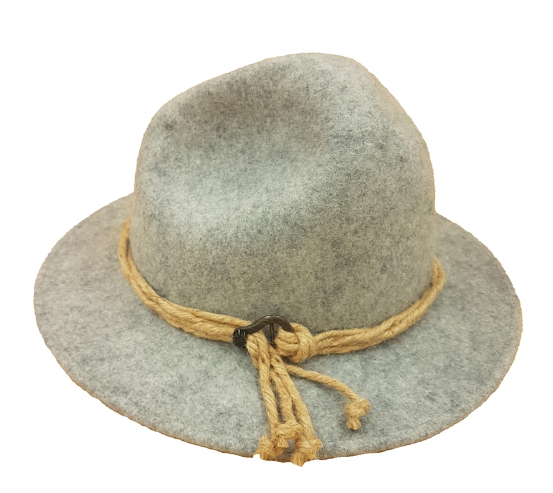 May include: A gray fedora-style hat with a wide brim. The hat features a tan rope band with a decorative knot and tassel. The hat is made of a soft, felt-like material.