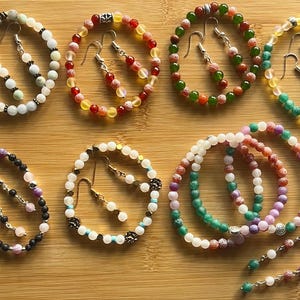 May include: A handmade wooden sign displaying the word "Welcome" in a whimsical font. It has a distressed white background and a dark stained wooden frame, suitable for a front door or hallway.