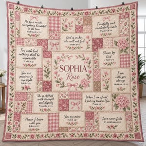 May include: A patchwork quilt featuring a central floral wreath with the name Sophia Rose, surrounded by rectangular panels containing various Bible verses, pink gingham patterns, and floral prints in shades of dusty rose and cream.