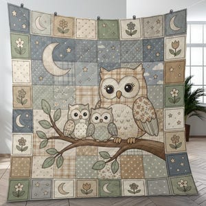 May include: A patchwork quilt featuring a family of owls perched on a branch. The quilt has a repeating pattern of squares with moons, stars, and flowers in shades of blue, green, and tan. The owls have large eyes.