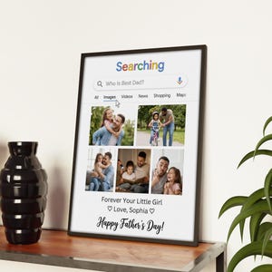 May include: A framed print with a black border, featuring a collage of photos of a father and child. The print has a search bar graphic with the text "Who Is Best Dad?" and the words "Happy Father's Day!" and "Forever Your Little Girl Love, Sophia".