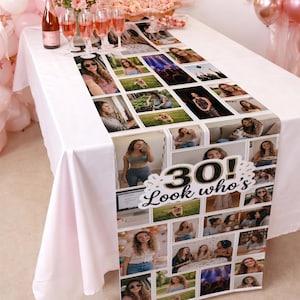 May include: A white table runner with a collage of photos and the text "30! Look who's". The runner is decorated with photos of a woman. Champagne glasses and a bottle of champagne are on the table.
