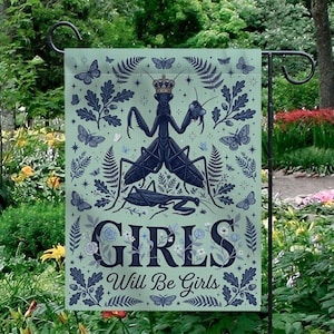 May include: A garden flag with a light green background featuring a dark blue illustration of a praying mantis wearing a crown, surrounded by butterflies and foliage. The words "GIRLS Will Be Girls" are at the bottom.