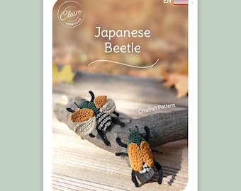May include: A crochet pattern for a "Japanese Beetle" with two handmade beetles in tan, black, and green. They are positioned on a wooden branch. The background is blurred. The pattern is labelled "Crochet Pattern".