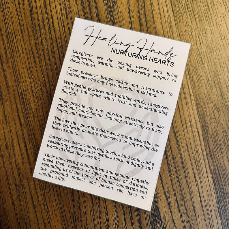 May include: A white card with a brown wooden background. The card has a title that reads "Healing Hands Nurturing Hearts". The text on the card describes the importance of caregivers and their impact on the lives of others.
