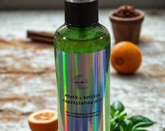 May include: Green glass spray bottle with a holographic label that reads "Money + Success Manifestation Mist". The bottle contains a green liquid and is 3.4 oz. The image includes cinnamon sticks, oranges, and basil.