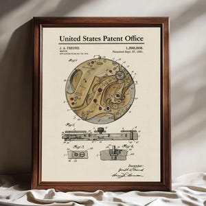 May include: Framed vintage patent print of a watch mechanism. The print features detailed technical drawings in sepia tones, with the text "United States Patent Office" at the top. The patent number is 1,392,006.