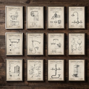 Puede incluir: Una colección de grabados de patentes vintage enmarcados que presentan accesorios de baño, incluyendo inodoros, bañeras, duchas y grifos. Los grabados son en blanco y negro, con el texto "United States Patent Office" en la parte superior de cada marco. Los marcos se muestran en una pared de madera.