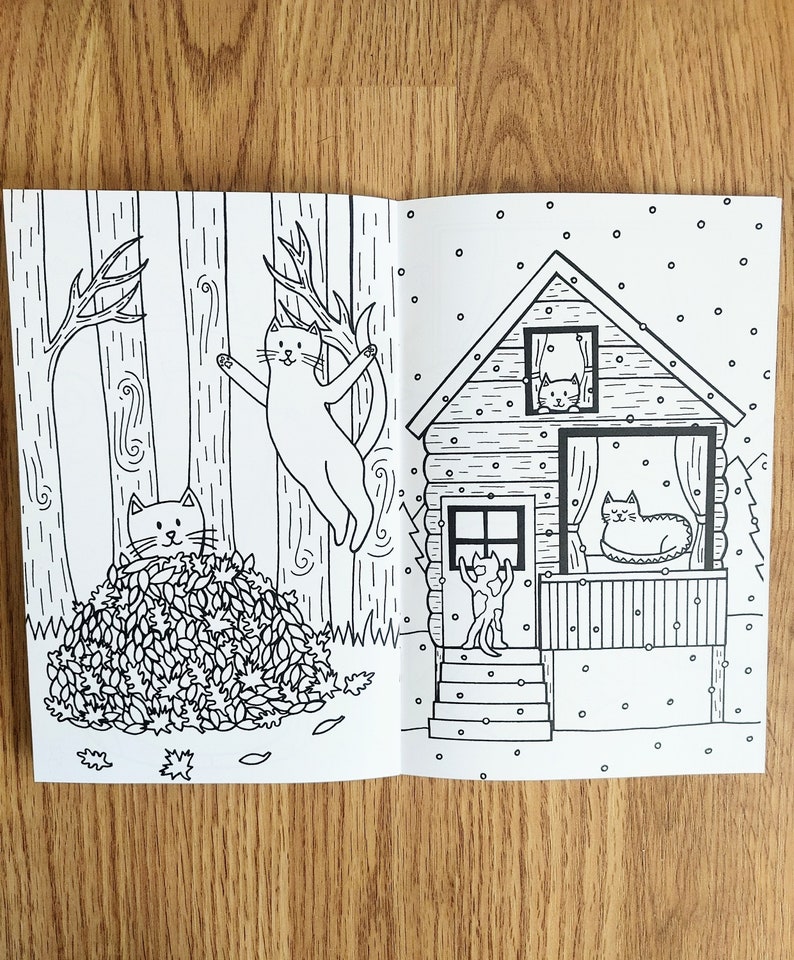 May include: Black and white illustration of a cat climbing a tree, another cat hiding in a pile of leaves, and a third cat looking out of a window in a cabin. The cabin has a porch with a cat sitting on it. The scene is set in a forest with snow falling.