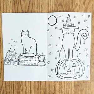 May include: A black and white coloring book page featuring two illustrations of cats. The first cat is sitting on a stack of books with the text "Witchcraft 101, 100 Spooky Spells, What Your Black Cat Is Trying To Tell You." The second cat is wearing a witch's hat and sitting on a jack-o'-lantern. Both cats are surrounded by stars.