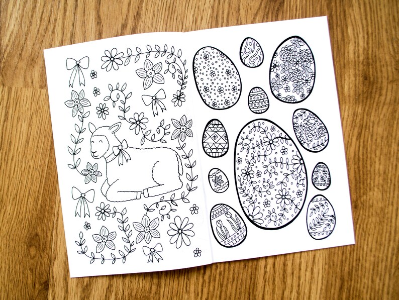 May include: A black and white coloring page featuring a lamb surrounded by flowers and a variety of eggs with intricate designs.