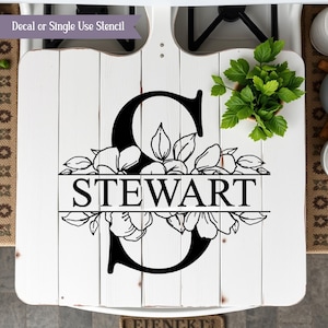 May include: White wooden sign with a black floral design and the letter "S" and the name "STEWART" in black lettering.